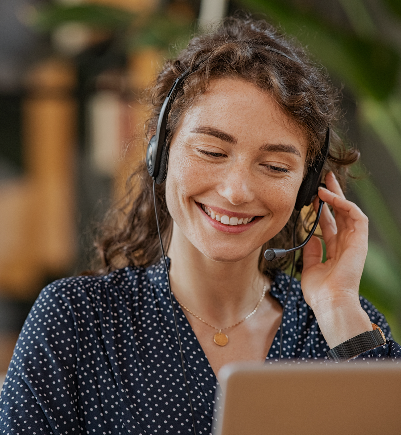 Happy woman working remotely on laptop