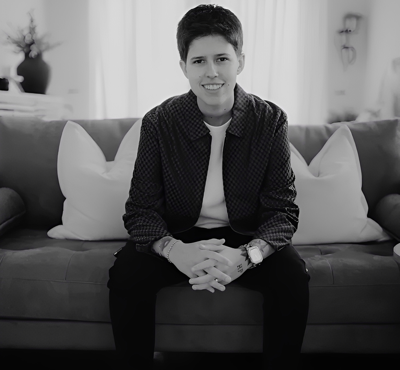 Person sitting on a couch with pillows